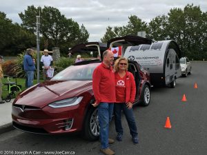 Silke & Rolf in front of their Model X and trailer at Mile Zero